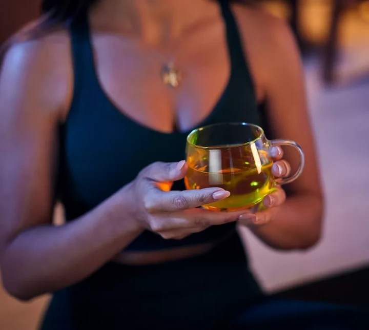 li-woman-holding-tea-night.webp