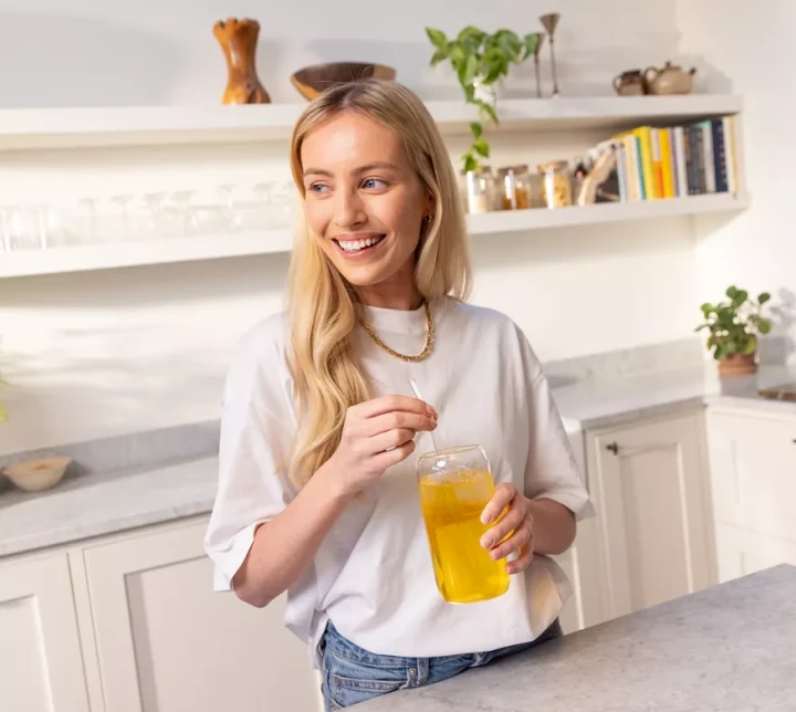 li-woman-in-a-kitchen-holding-and-stirring-a-glass.webp